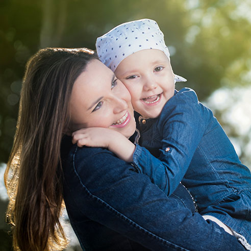 Woman holding child with bandana